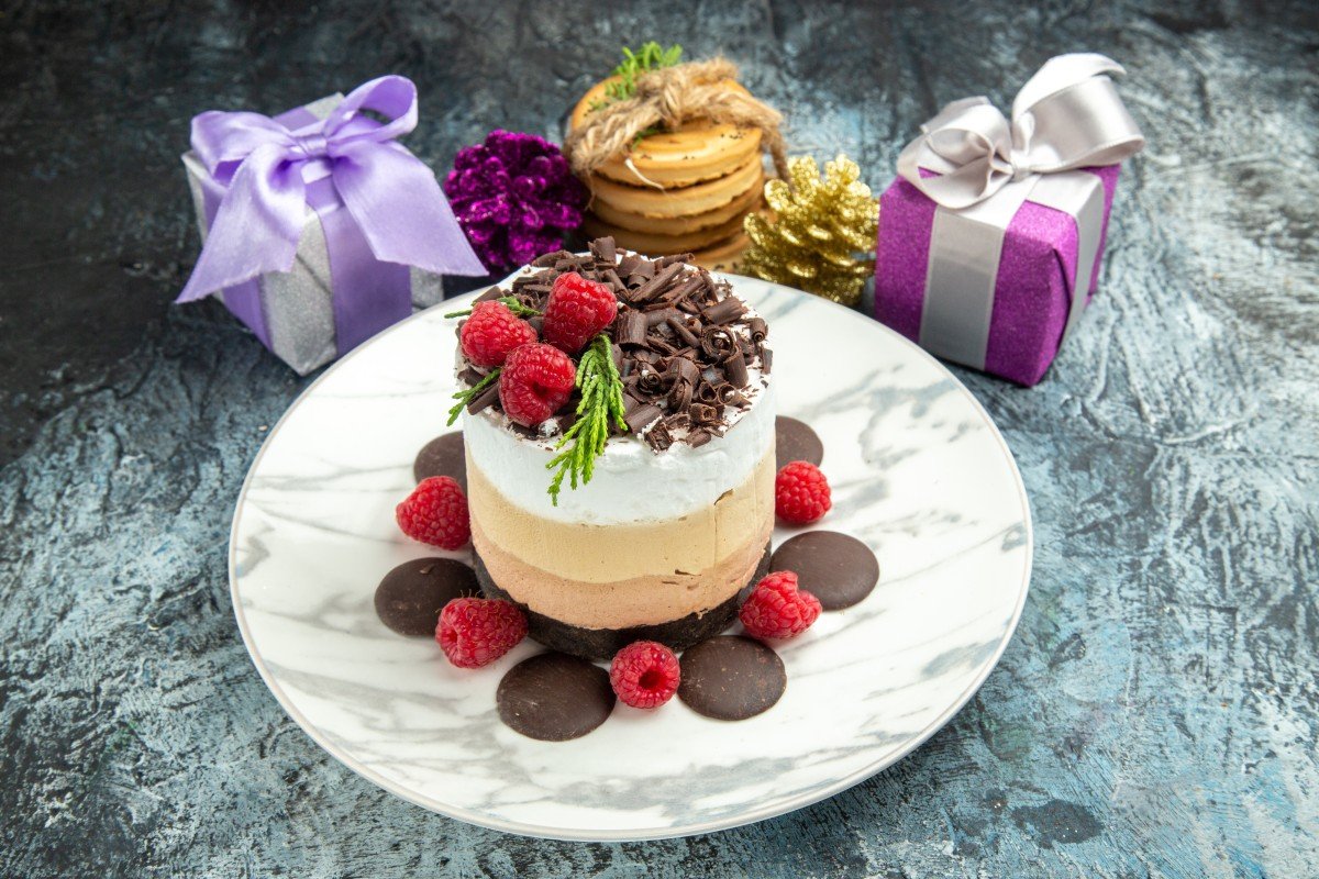 front view cheesecake with chocolate oval plate tied cookies xmas ornaments grey background (1)