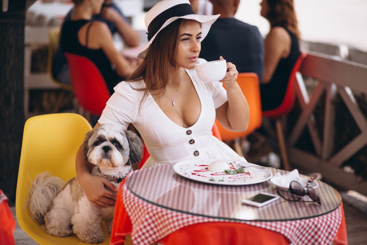 young lady bar with cute dog having lunch (1)